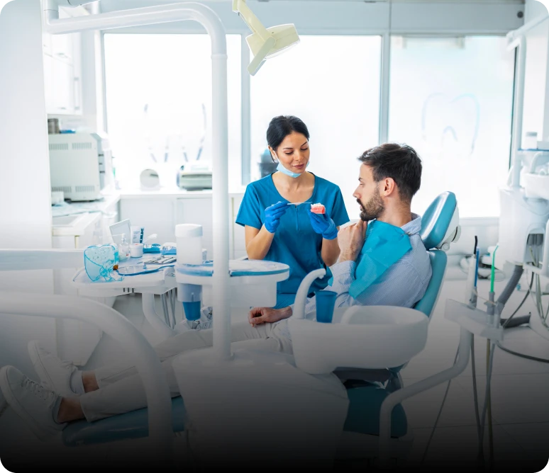 Dentist explaining dental model to patient
